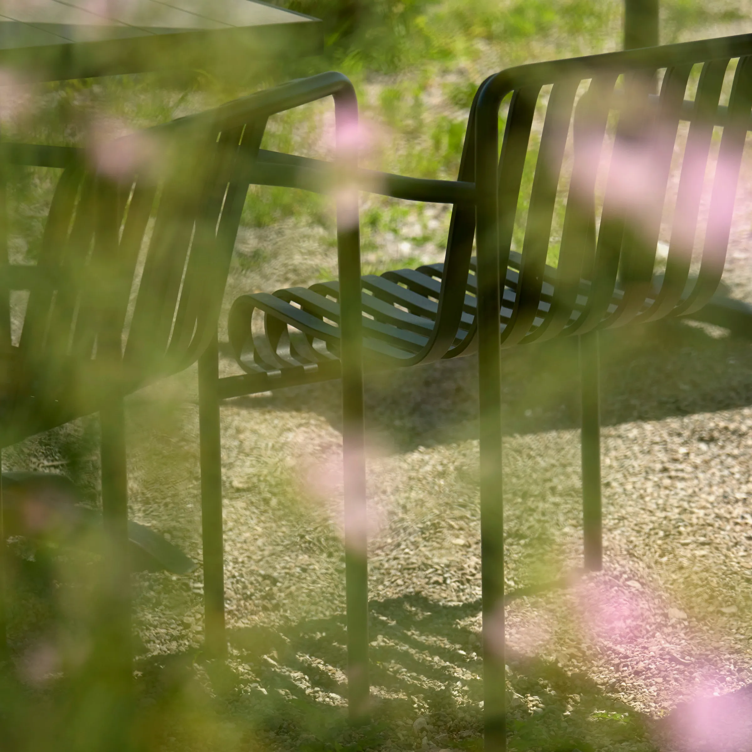 Patio chairs shot through vegetation at Pearl Morissette