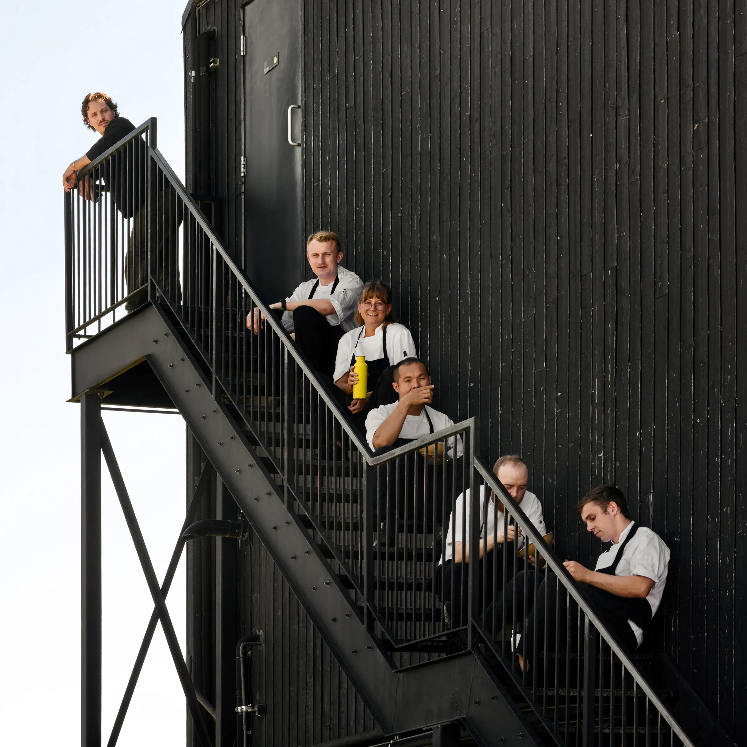 Group portrait of chefs along a staircase at Pearl Morissette