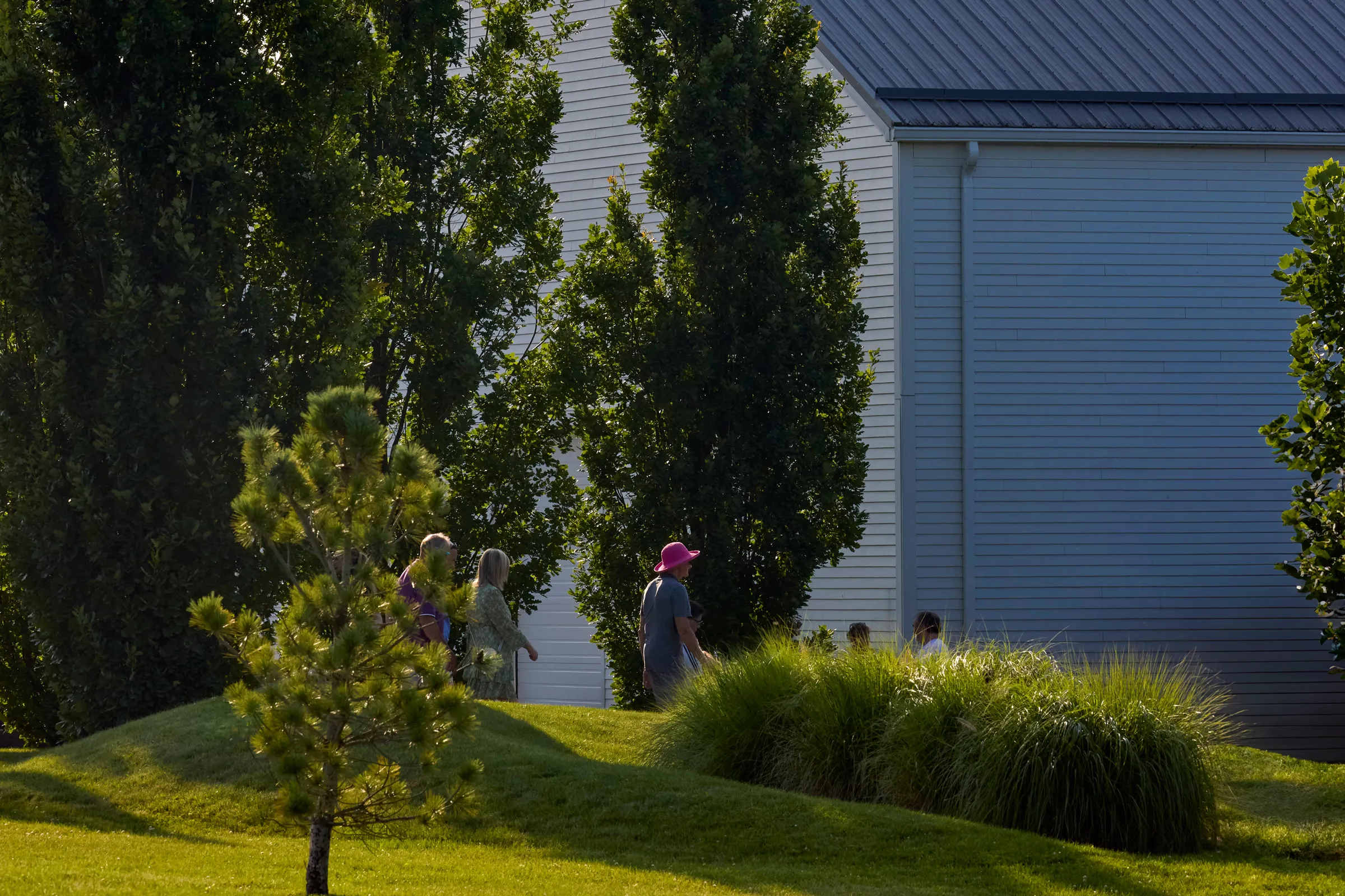 A group of visitors walking in front of 13th Street Winery